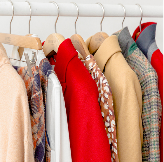  Image of a rail showing autumn knitwear, coats and dresses.